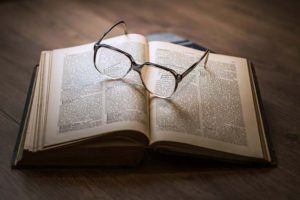 open book with glasses